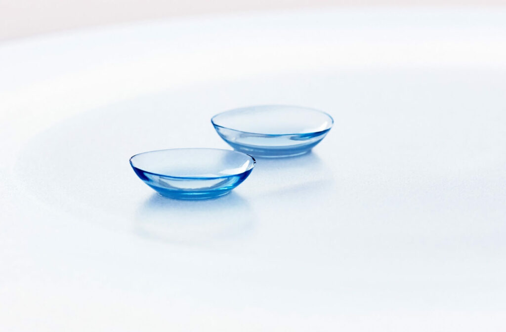 A close-up of a pair of contact lenses against a white background.
